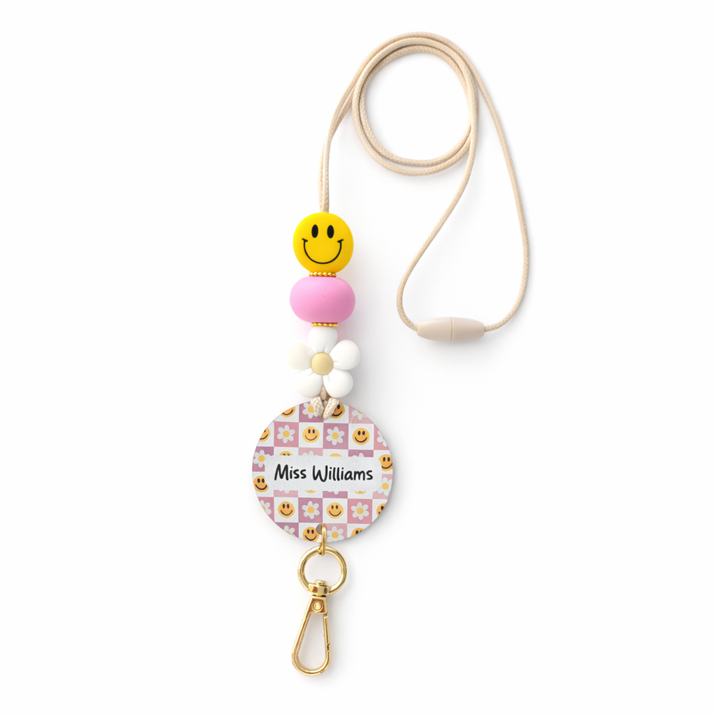 Decorative lanyard with colorful beads and a name tag on a white background