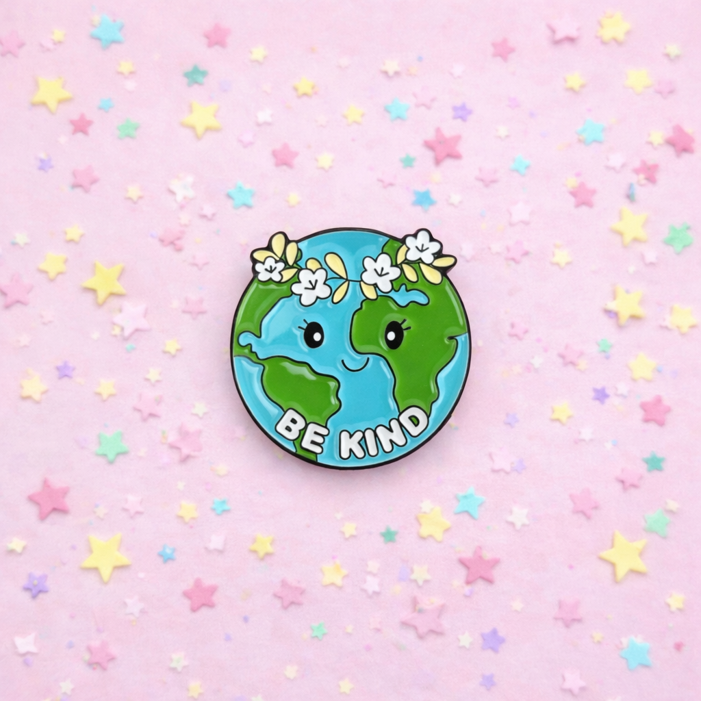 Pin with a cartoon Earth and 'Be Kind' text on a pink background with stars