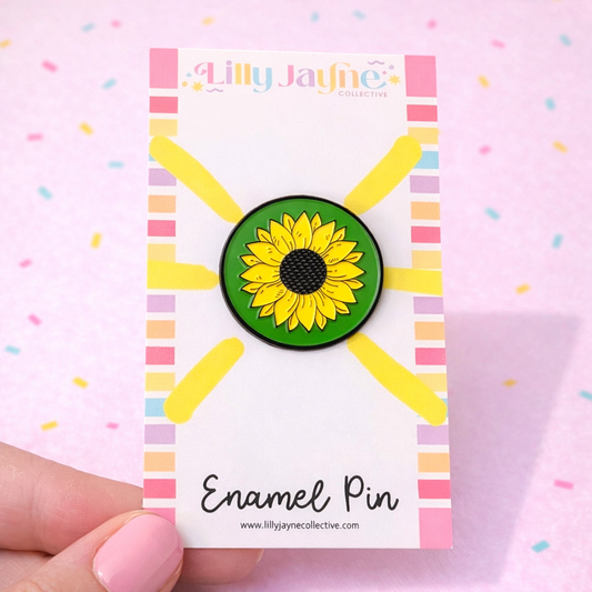 Sunflower enamel pin on a colorful card with 'Lilly Jayne Collective' branding.