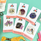 Collection of Needle Minder pins on their packaging with a green background