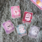 Five book-themed stickers on a textured surface