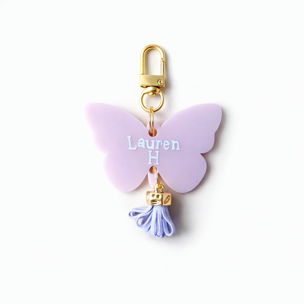 Butterfly-shaped keychain with 'Lauren H' engraving on a white background
