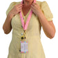 Person wearing a yellow dress with a pink lanyard and badge holder.