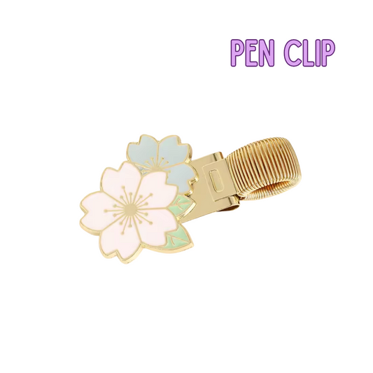 Gold pen clip with floral design on a white background