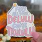 Sticker with text 'May all your Delulu come Trululu' held in front of a blurred background