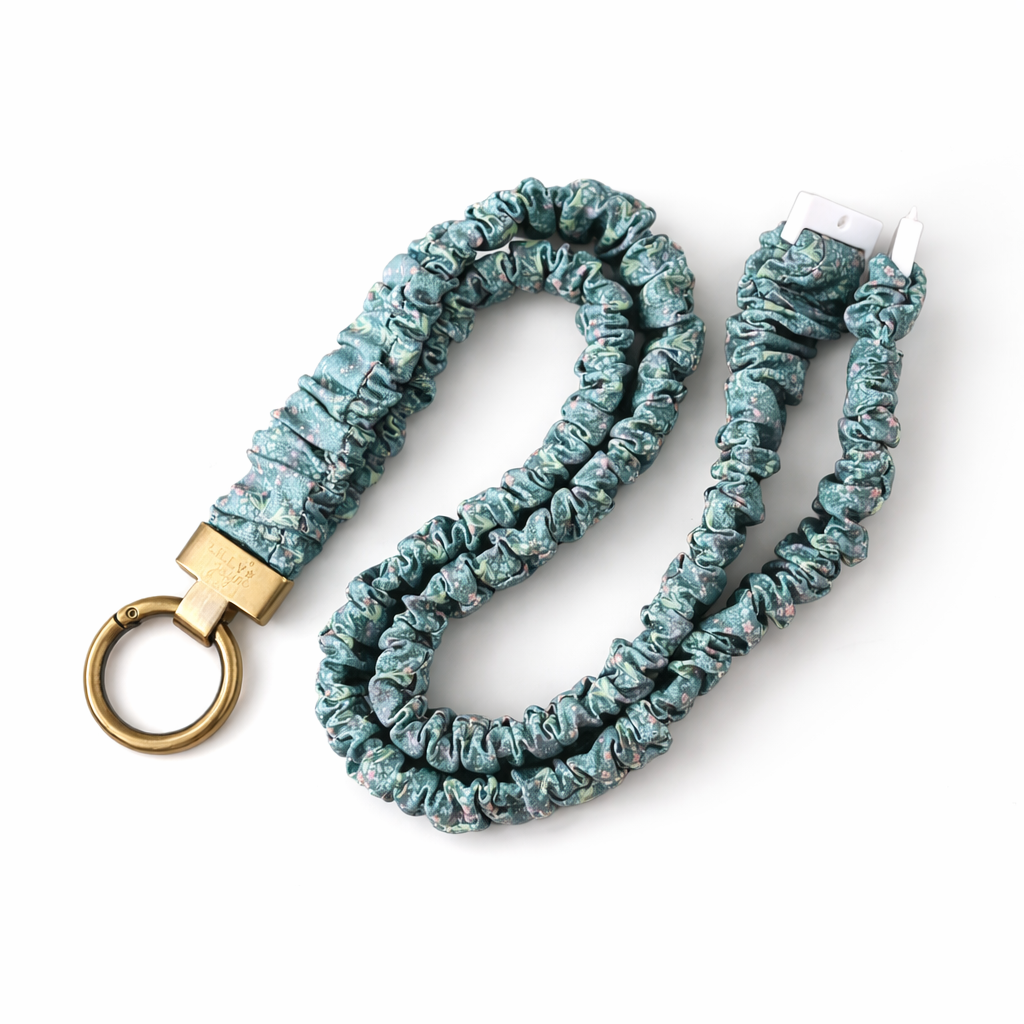 Teal scrunchie lanyard with gold key ring on a white background