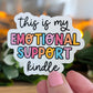 Sticker with colorful text 'this is my emotional support kindle' held by a hand.