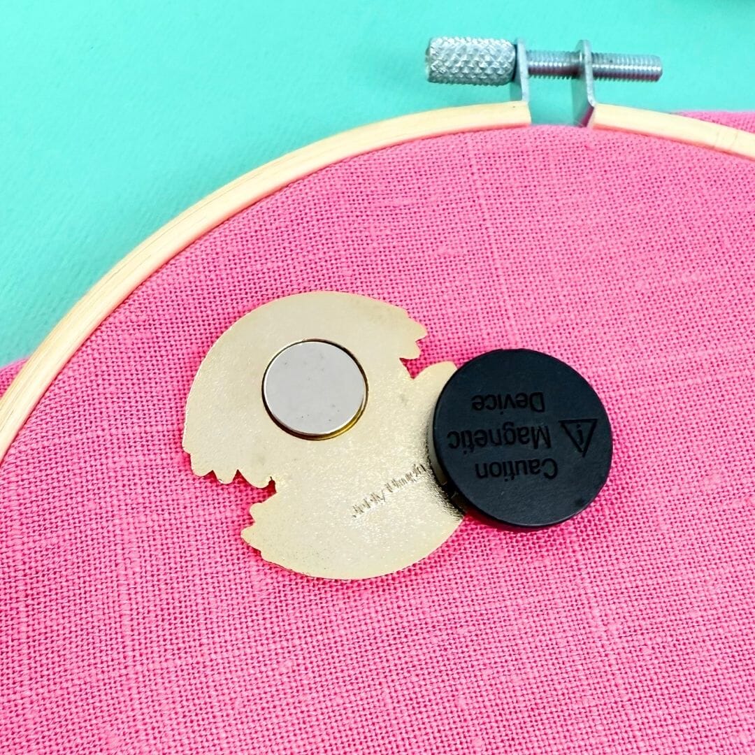 Magnetic device on a pink fabric background